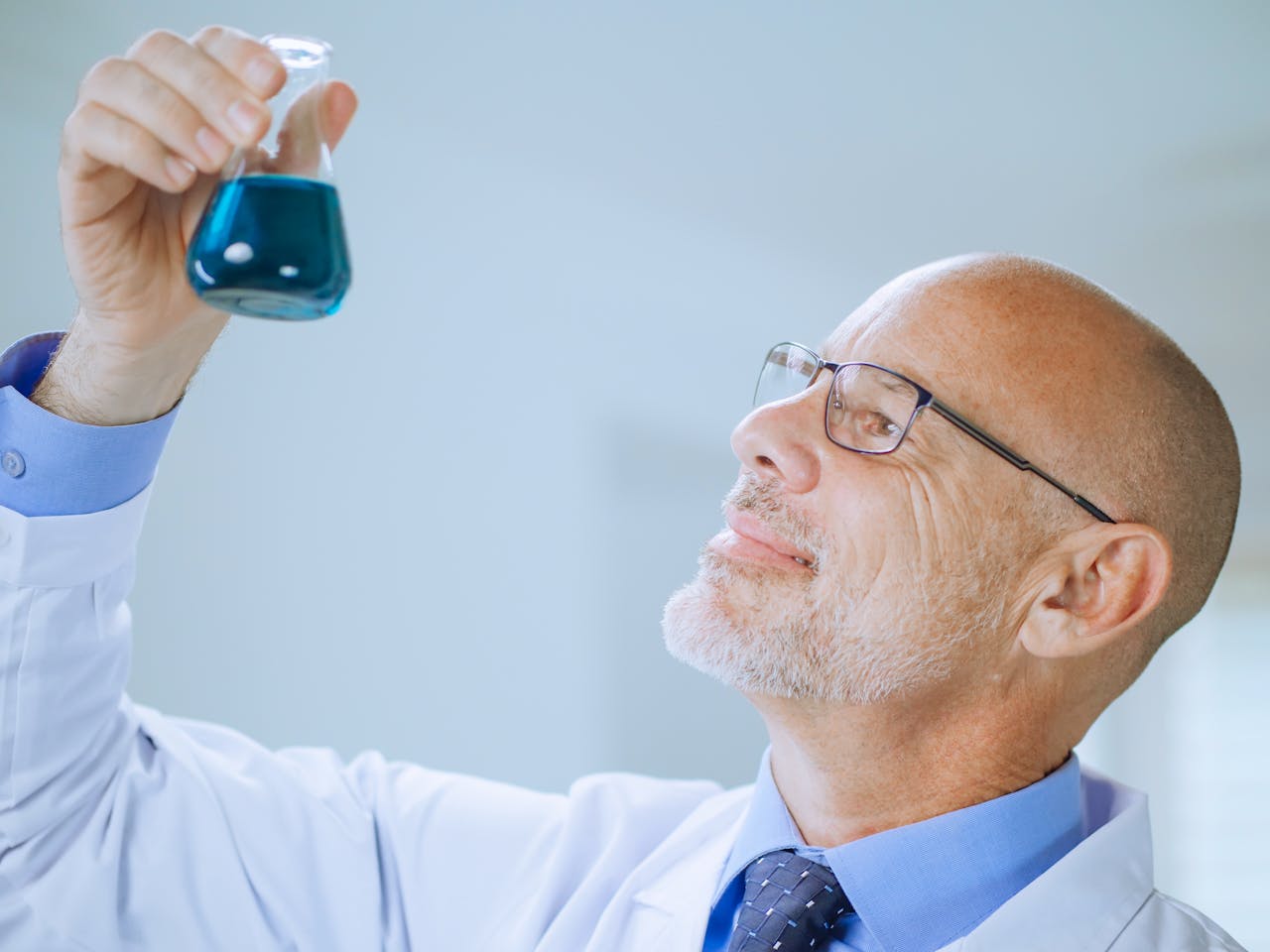 A Man in White Coat Doing an Experiment